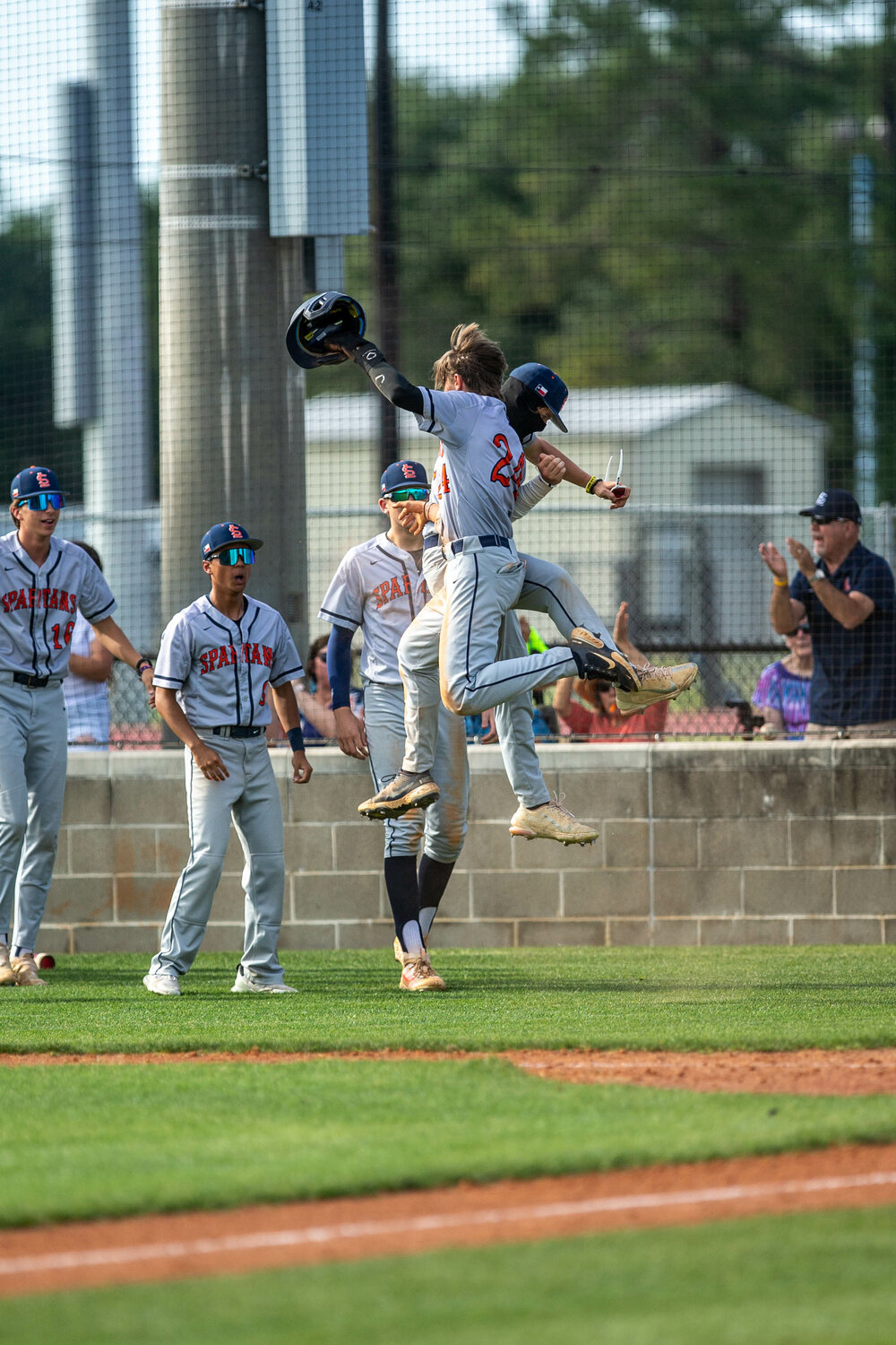 Seven Lakes players celebrate during Monday's District 19-6A play-in game between Seven Lakes and Taylor at the Mayde Creek baseball field.